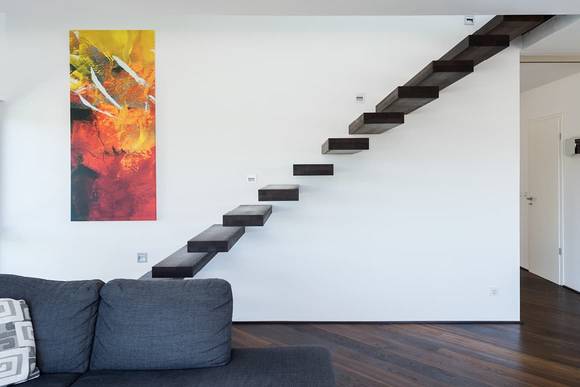 Ein absolutes Highlight in dem individuellen Fertighaus in Netphen ist die freischwebende, moderne Treppe.